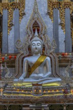 Richly decorated Buddha statue at Wat Suthiwararam Buddhist temple, Bangkok, Thailand's metropolis,