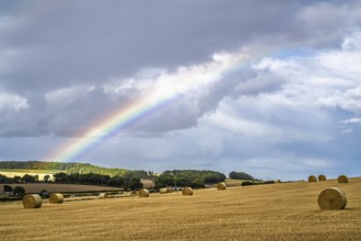 Rainbow over Straw bales, Scottish fields, Southeast Scotland, UK