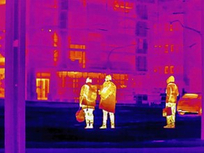 Thermal image or thermography, symbolic photo, interpolated. People traveling in urban areas.