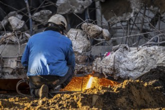 Workers with cutting torches demolishing the 120-meter long motorway bridge of the A516, across