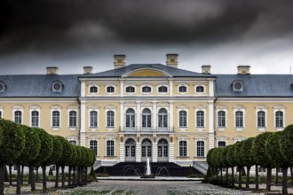 Magnificent baroque castle with imposing façade under dramatic clouds, Rundale, Latvia