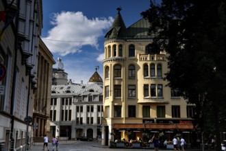 Historic buildings on Livu Square in Riga, including the Cat House, in sunny skies, Riga, Latvia