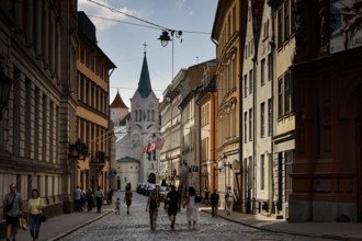 Castle Street with Maria Schmerzen Church and lively street life in Riga, Riga, Latvia