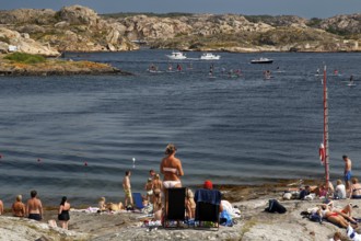 Summer beach on Klädesholmen with relaxed atmosphere and people bathing, Klädesholmen, Sweden