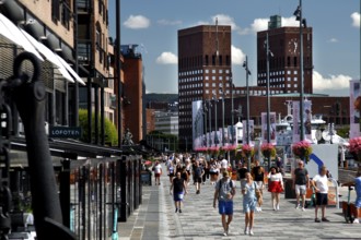 Busy street with views of Oslo City Hall and crowds, Oslo, Norway