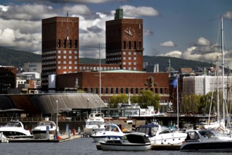 View of Oslo Red City Hall from Tjuvholmen with harbour and boats, Oslo, Norway