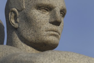 Detail of a granite sculpture in Vigelandsparken shows concentrated face, Oslo, Norway