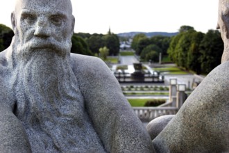 Granite figures in Vigeland sculpture park with green parkland in the background, Oslo, Norway