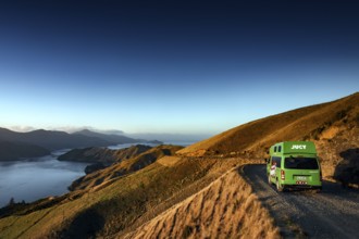 Camper drives along picturesque French Pass Road overlooking a sound, French Pass Road, South