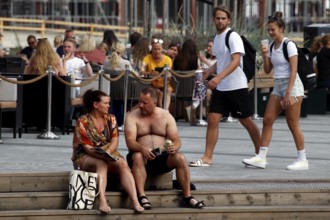 People talking relaxed on a jetty in Bjøvika, Oslo, Bjøvika, Norway