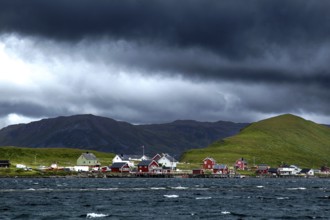 View of Sarnes village with surrounding hills and cloudy sky, Sarnesfjord, Norway