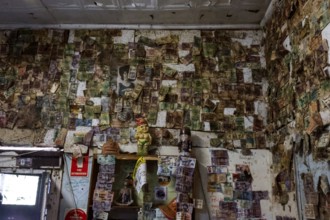 Historic interior of a hotel along the Stuart Highway, covered with notes and reminders, zero