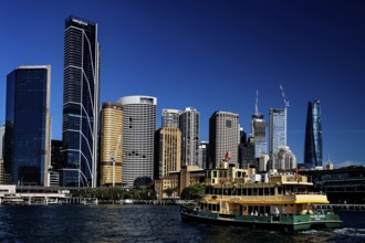 Sydney cityscape with passing ferry and skyscrapers in the background, Sydney, New South Wales,