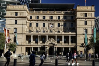 Historic view of Customs House with passers-by and colorful flags, Sydney, New South Wales,