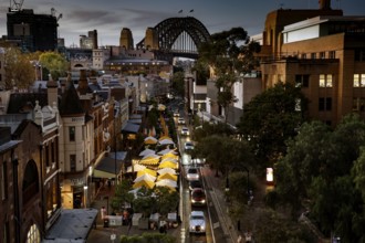 Evening atmosphere over The Rocks with a view of the illuminated Harbour Bridge, Sydney, New South
