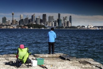 View of Sydney's skyline from Bradleys Head with people fishing in the foreground, Sydney, New