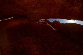 Light rays penetrate the tight, reddish brown Echidna Chasm, Purnululu, Western Australia,