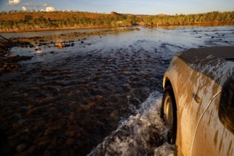 A vehicle crosses the Pentecost River through a shallow ford when the sun is low, Pentecost River,