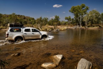 Vehicle crosses shallow river in remote area of Purnululu National Park, Purnululu National Park,