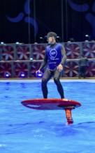 Press photo dynamic photo of eFoil surfer in the large XXL pool in Hall 17 of Messe Boot