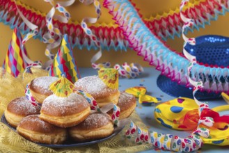 A plate of donuts surrounded by colorful party hats, streamers and garlands, carnival