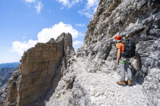 Climbers on the Via Ferrata Brentari via ferrata, spectacular mountain landscape with steep cliffs,
