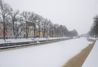 Historic buildings on the frozen Aurajoki river, wintery Turku or Swedish Åbo, Varsinais-Suomi,