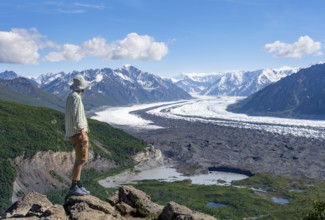 Young man enjoying the view, view of impressive mountain landscape with Matanuska glacier and