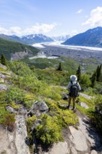 Young man enjoying the view, view of impressive mountain landscape with Matanuska glacier and