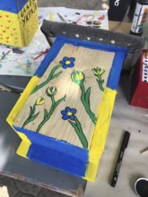 Lower Saxony, Germany, painted bird house in blue and yellow with flowers. Ukrainian students'