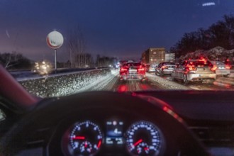 Driving in winter, in snow, motorway, rear lights, brake lights, speedometer, cockpit