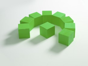 9 green wooden cubes against a white background