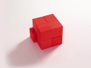 8 red wooden cubes against a white background