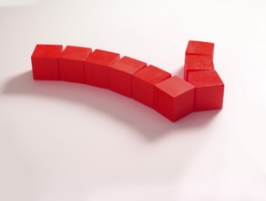 9 red wooden cubes against a white background