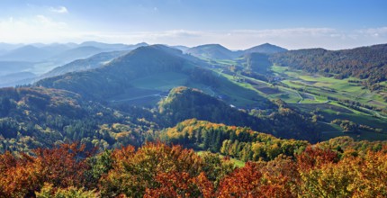 View of an autumnal forest from the Gisliflue, behind the Jura foothills with Wasserfluh and