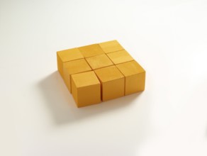 9 yellow wooden cubes against a white background