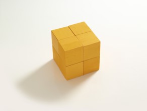 8 yellow wooden cubes against a white background