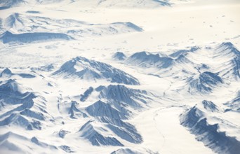 Icy, snowy arctic mountain landscape with glaciers, aerial view, Greenland, Arctic
