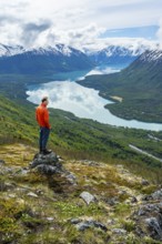 Climber enjoying the view, Slaughter Ridge Trail, view of snowy mountains and turquoise blue Kenai