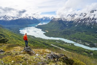 Climber enjoying the view, Slaughter Ridge Trail, view of snowy mountains and turquoise blue Kenai