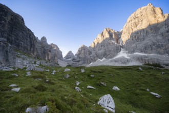 Picturesque mountain landscape in Val Brenta Alta at sunrise, rocky peaks of Cima Tosa,