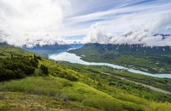 View of snowy mountains in spring and turquoise blue Kenai Lake, Slaughter Ridge Trail, Cooper