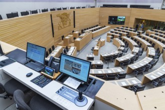 Plenary hall deserted with the seats of deputies and the government bank. Behind it is the