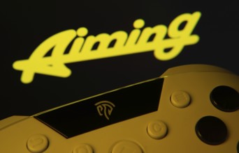 Dhaka, Bangladesh- 24 Mar 2025: A close-up of a gamepad with the Aiming Inc seen on screen in the