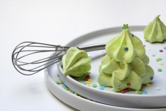 Meringue in the shape of a Christmas tree and whisk, Christmas cookies, meringue