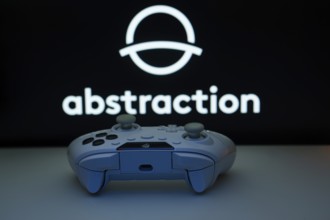 Dhaka, Bangladesh- 08 Apr 2025: A gaming controller in front of a Abstraction screen