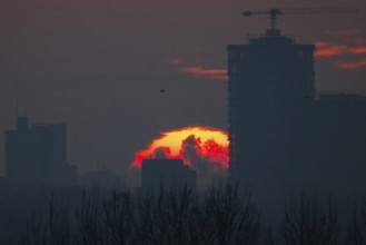 The sun rises behind Frankfurt's banking skyline, Frankfurt am Main, Hesse, Germany