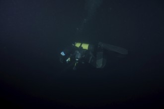 Divers at night in Lake Walen. Tauchplatz Känzeli, Mols, Canton of St. Gallen, Switzerland