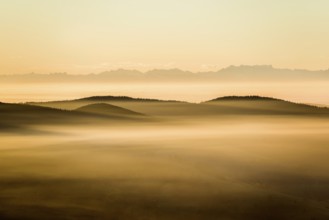 View from Belchen heading south of Wiesental and the Swiss Alps, morning atmosphere with fog in