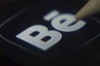 Dhaka, Bangladesh- 06 Dec 2025: Close-up of the Behance app on a screen with a stylus pointing at